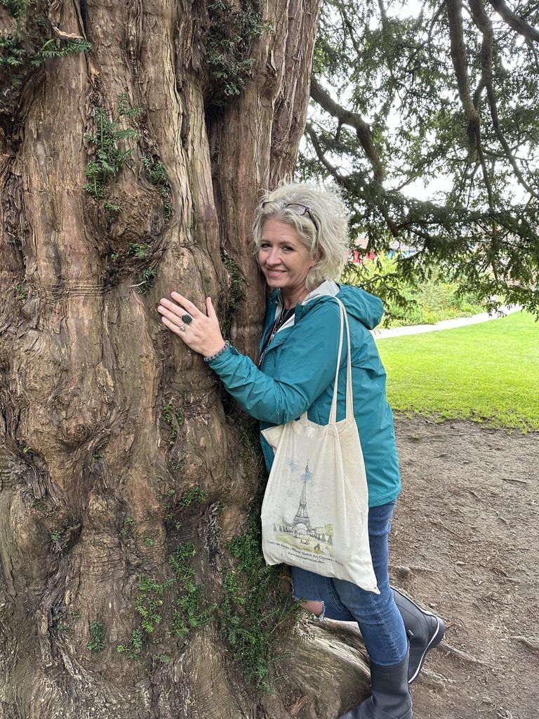 Christy with the ancient yew tree at Glastonbury